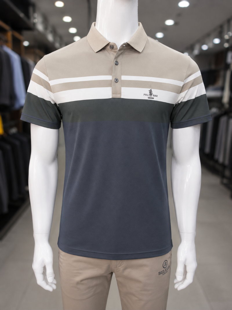 A men's short-sleeve polo shirt, The shirt features a color-blocked design with a dark slate blue lower section, a beige upper chest and collar, and white and dark green horizontal stripes across the chest and sleeves.