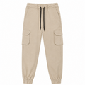 Beige cargo jogger pants with a black drawstring, elastic cuffs, and side cargo pockets.