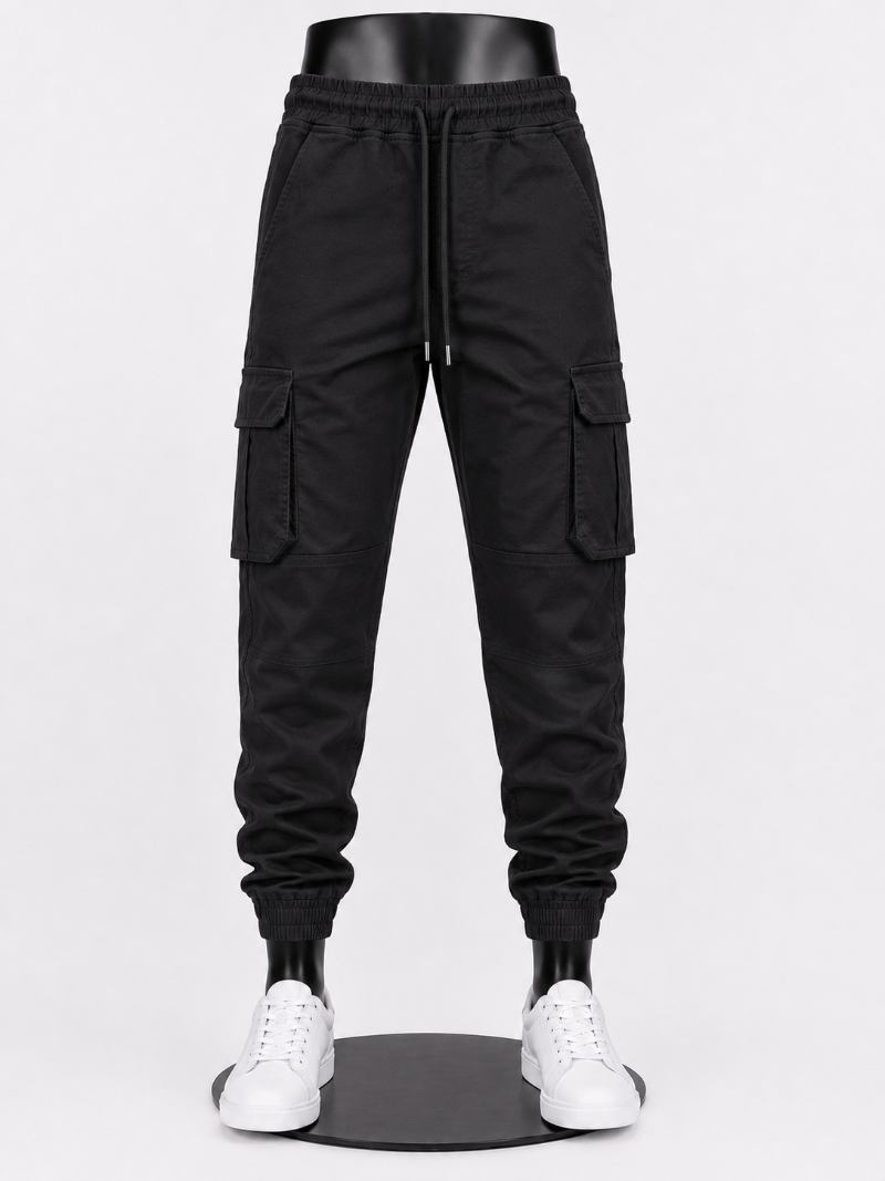 Black cargo jogger pants with side flap pockets, a drawstring waist, and elastic.