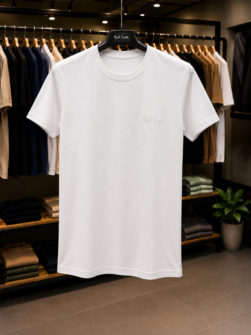 A White t-shirt with 'Paul Smith' in 100% Cotton.