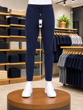 A Neavy Blue stretchable lycra Trouser, 100% lyra dry fit, elastic waistband, premium zipper pockets, and stretchable fabric.